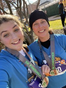 Jaime and her daughter at a race finish line... she runs, in part, to be a good role model for her daughters...